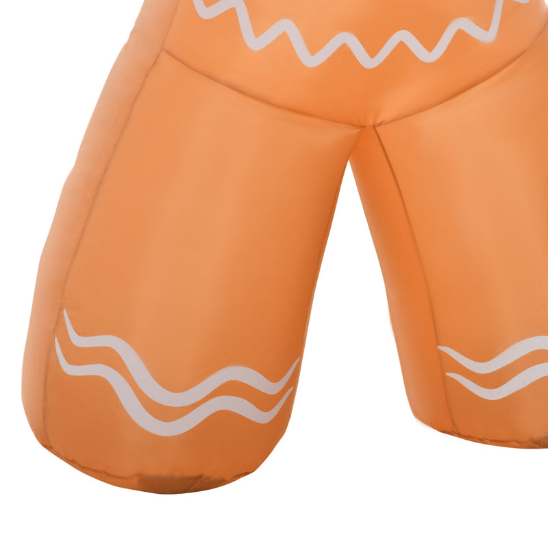 Close-up of the gingerbread man's legs with white wavy icing pattern