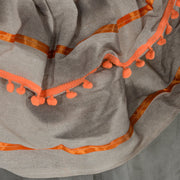 Close-up of the orange pom-pom trim on the robe of the Homcom orange clown animatronic