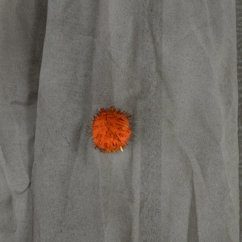 Close-up of the fabric button detail on the robe of the Homcom orange clown animatronic