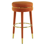 Orange velvet bar stool with velvet-covered legs on a plain background