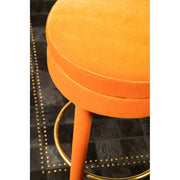 Orange velvet bar stool beside a kitchen counter