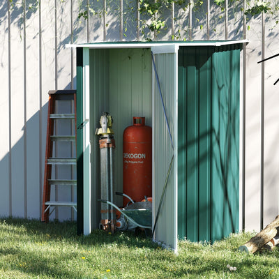Green lean-to metal shed against a fence with a ladder, gas bottle and tools inside