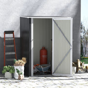 Grey lean-to shed on a patio with the door open and a wheelbarrow inside
