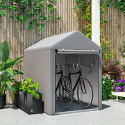 Light grey shed tent on a patio storing two bicycles in front of a wooden fence