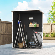 Interior view of the shed holding a step ladder, garden tools, a wall shelf and an air vent