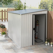 The white lean-to shed on a paved patio with the door slid open, showing tools stored inside