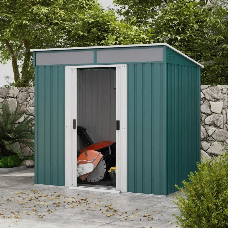 Green metal shed on a patio with its sliding doors open and a mower stored inside