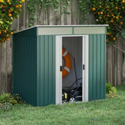 Green metal garden shed beside a fence and orange trees with a door slid open