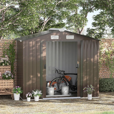 Brown apex metal shed in a garden with a bicycle and buckets stored inside