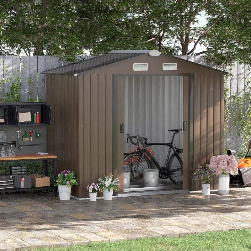 Brown metal shed beside a garden workbench with the sliding doors open