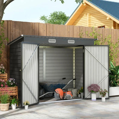 Dark grey shed on a patio with both doors open showing a mower and power tools inside