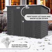 Dark grey shed standing in snow, captioned pent roof lets rain and snow slide down