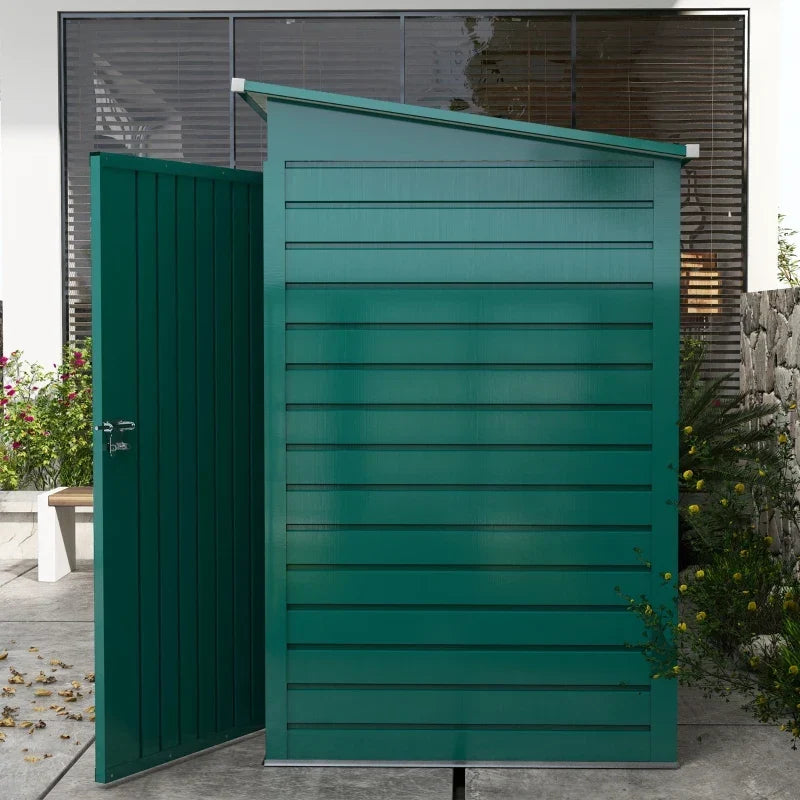 Side view of the green shed showing the pent roof sloping from front to back