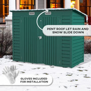 Green shed in snow showing the pent roof shedding snow, with the included safety gloves