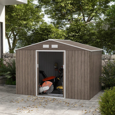 Brown metal garden shed on a patio with the sliding doors open and a lawn mower stored inside