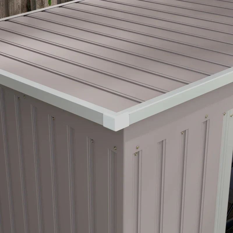 Close-up of the ribbed steel pent roof panels and the white edge trim along the shed corner