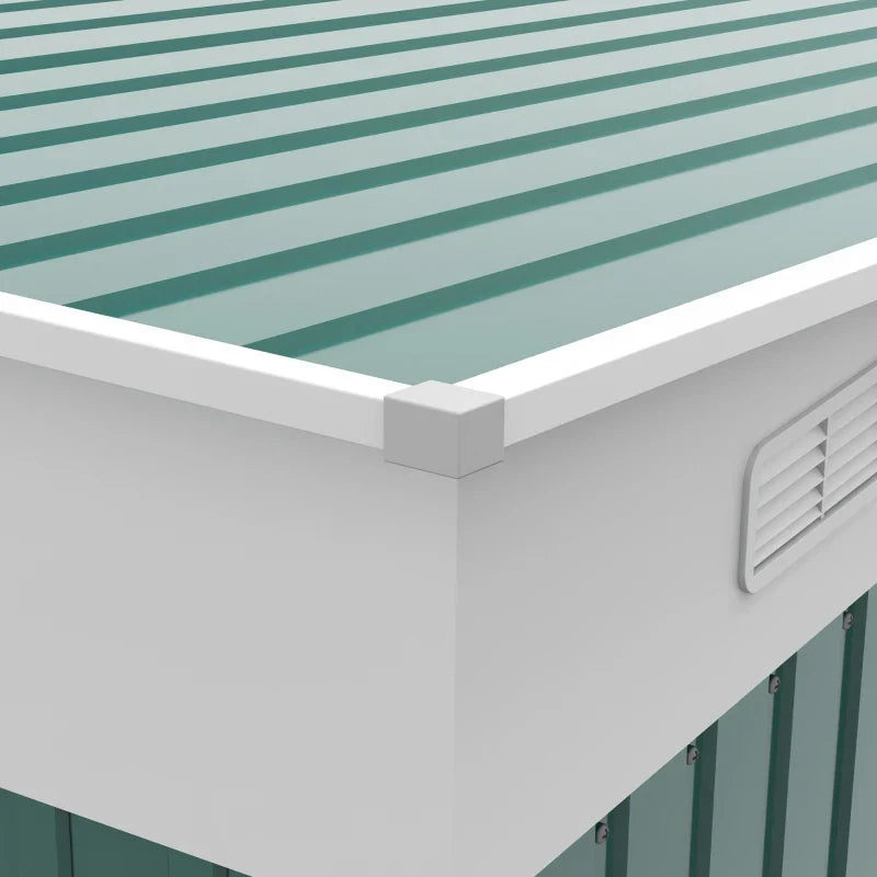 Close-up of the green corrugated roof panels, white eaves trim and a louvred wall vent