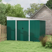 Green lean to metal shed on a lawn beside a picket fence and a timber cabin, doors closed and roof sloping to the front