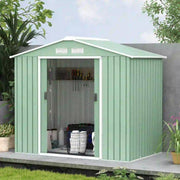 Light green metal shed against a wall with the doors open and a laundry basket inside