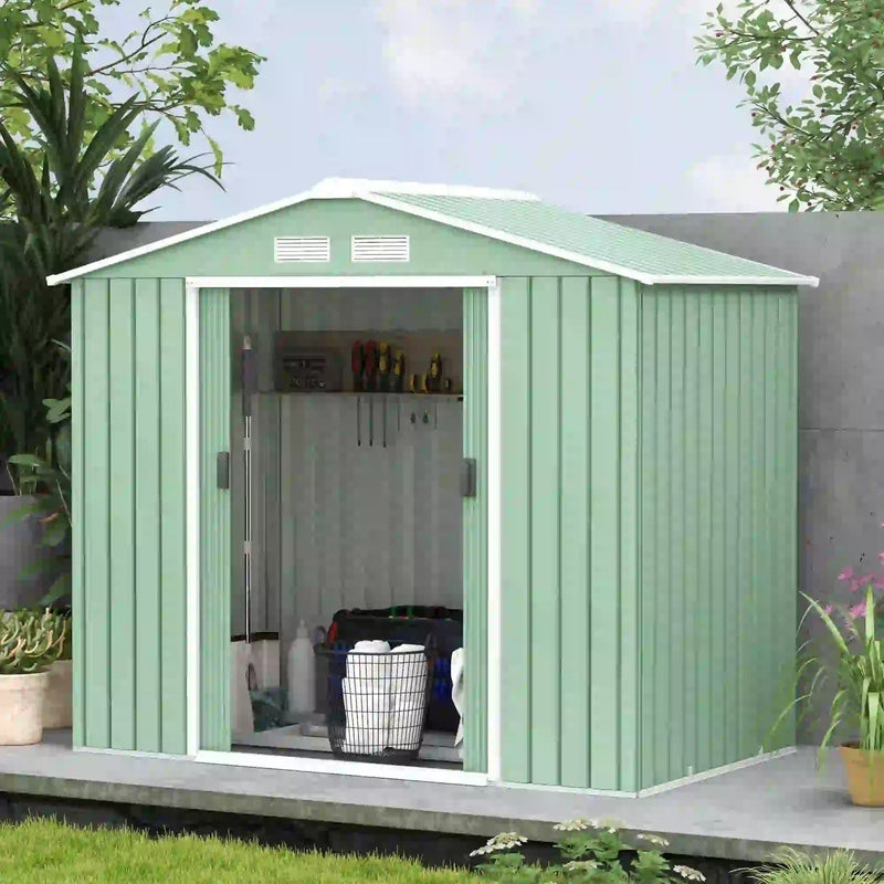 Light green metal shed against a wall with the doors open and a laundry basket inside