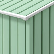 Close-up of the light green ribbed wall panels and the white roof edge trim