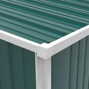 Close-up of the pent roof corner where the green roof sheet meets the white corner trim