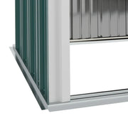 Close-up of the shed's open base rail at ground level, showing there is no floor panel fitted