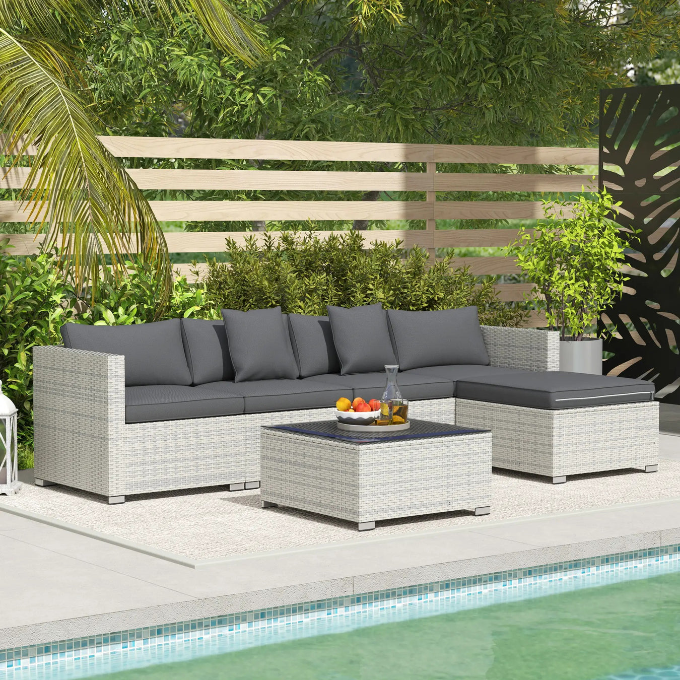 Image of a large rattan sofa with table and footstools