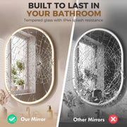 Oval LED mirror intact beside a cracked mirror, comparing shatter-resistant glass with IP44 splash protection