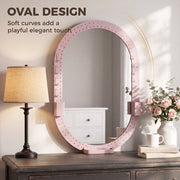 Oval mirror with pegboard frame above a dresser next to a table lamp