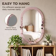 Oval pegboard mirror over a bookcase with make-up brushes in the pen holders