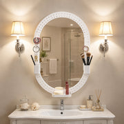 Oval pegboard mirror above a bathroom vanity between two wall lights