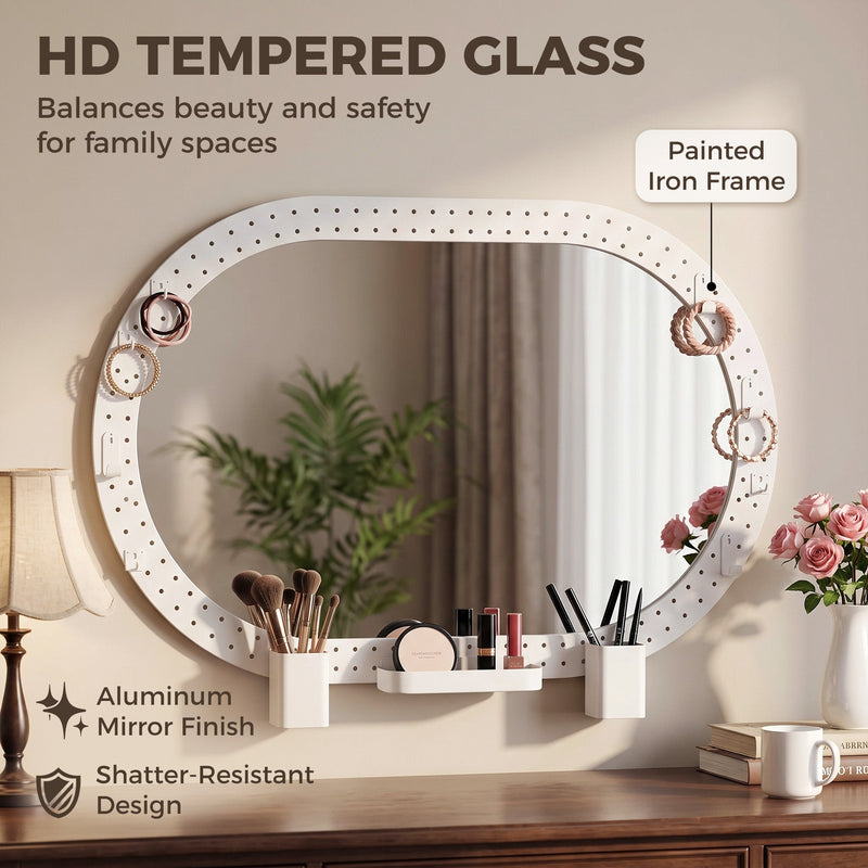 Oval mirror hung sideways above a dresser with tempered glass and painted iron frame callouts