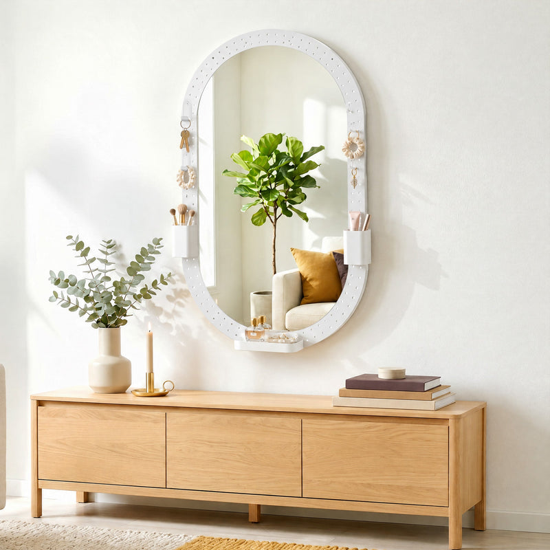 Oval pegboard mirror above a wooden sideboard with a plant and books