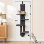 Cat shelf hanging on a white door with a cat on the top platform