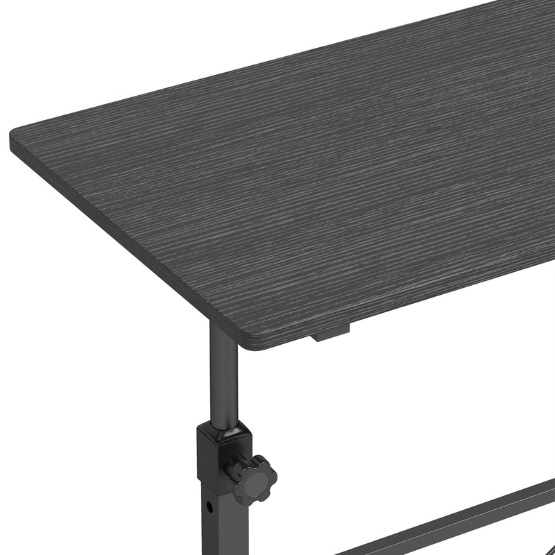 Close-up of the black tabletop corner, the height adjustment knob and the steel leg