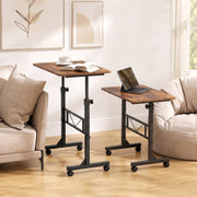 Two rustic brown overbed tables set at different heights beside a sofa and an armchair
