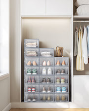 Songmics shoe storage boxes filled with shoes and clothing inside a wardrobe