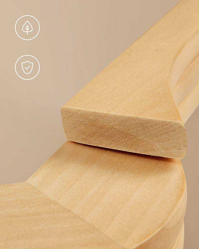 Close-up of a wooden hanger holding a folded jumper