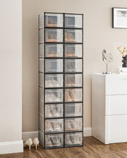 Two columns of stacked shoe boxes holding shoes against a bedroom wall