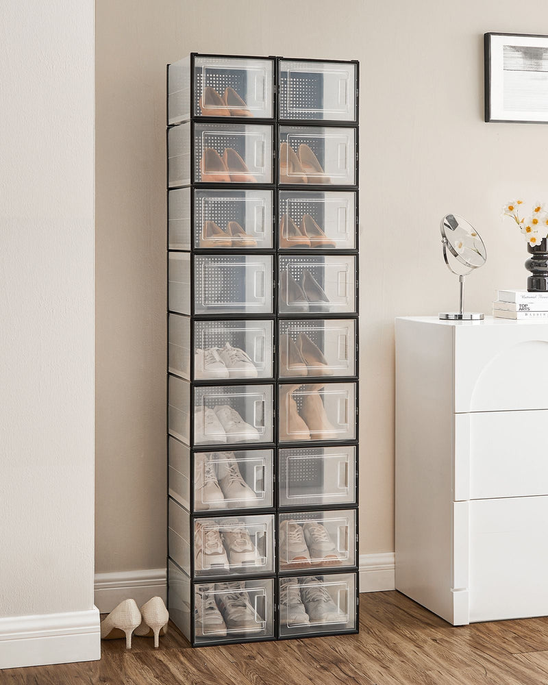 Two columns of stacked shoe boxes holding shoes against a bedroom wall