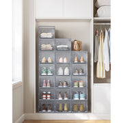 Grey shoe storage boxes stacked inside a fitted wardrobe alongside hanging clothes