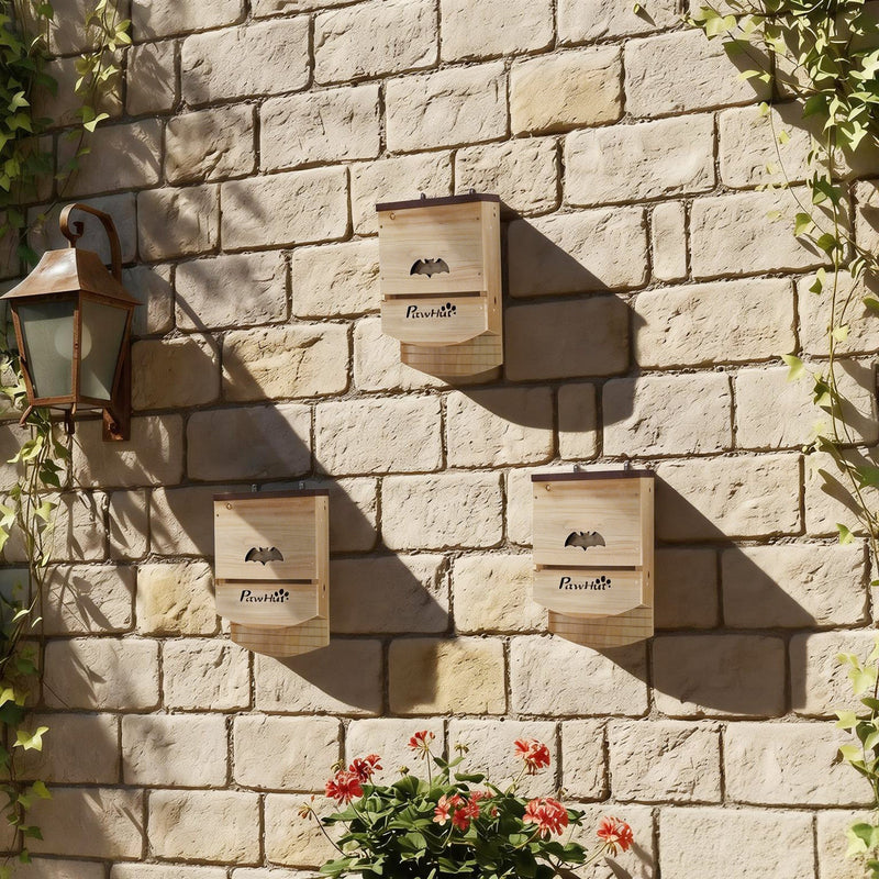 Three PawHut bat boxes mounted on a garden stone wall