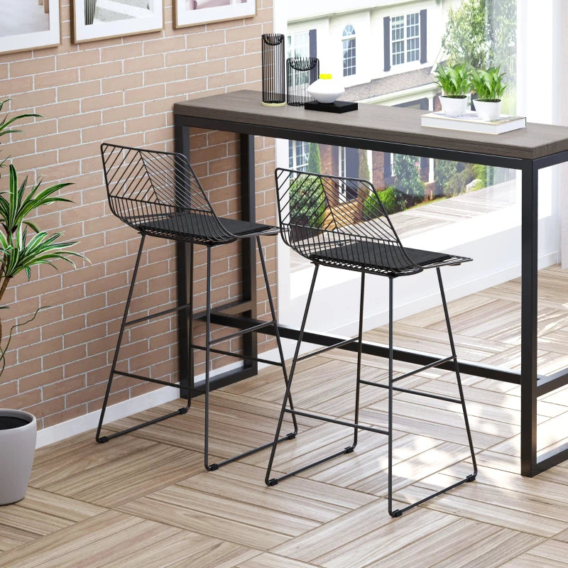 pair of modern black metal bar stooks in an open planned apartment kitchen diner