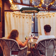 Couple enjoying a warm evening on the patio under the hanging heater