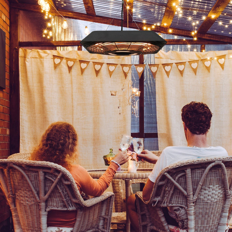 Couple enjoying a warm evening on the patio under the hanging heater