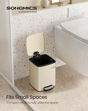 Sand beige pedal bin fitted in a small bathroom beside the toilet