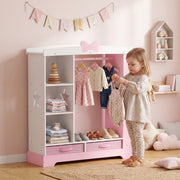 Young girl hanging clothes on the rail inside her pink kids wardrobe