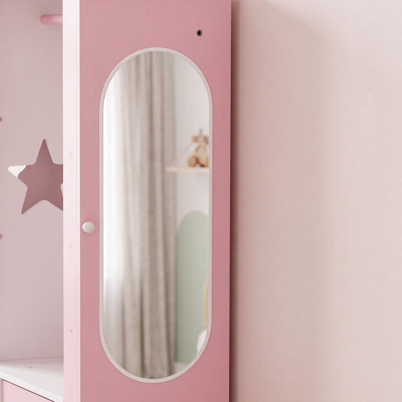 Close-up of the oval mirror set into the pink wardrobe door