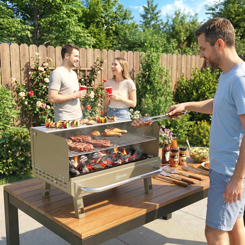 Khaki Outsunny charcoal BBQ grill in use on a garden table grilling meat and skewers